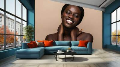 Beautiful African woman healthy and pure skin isolated on beige background Wall mural